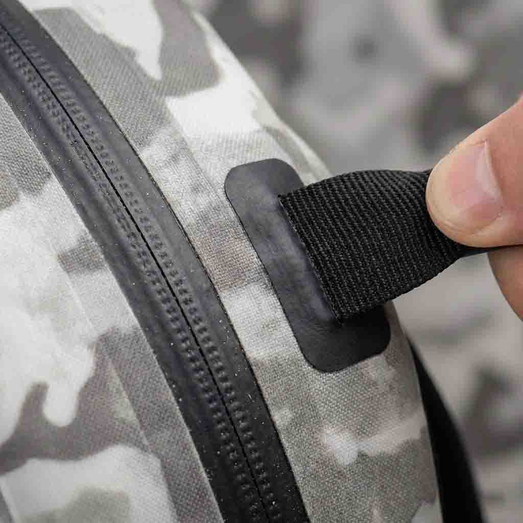 Macro view of perimeter-welded MOLLE web system and gas-tight zipper on a 15L fishing pack