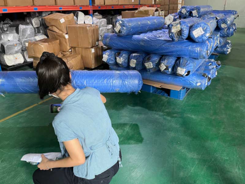 Inspector photographing and recording rolls for the customer's file