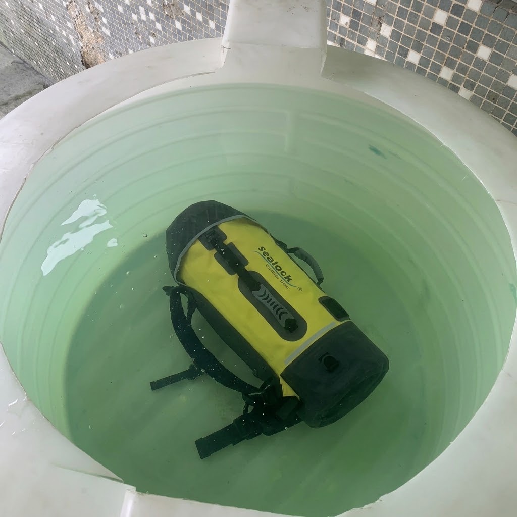Large IPX8 waterproof expedition backpack fully submerged in a test tank